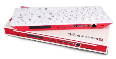 Klawiatura z wbudowanym komputerem Raspberry Pi 400 w białoróżowych kolorach leży na opakowaniu.